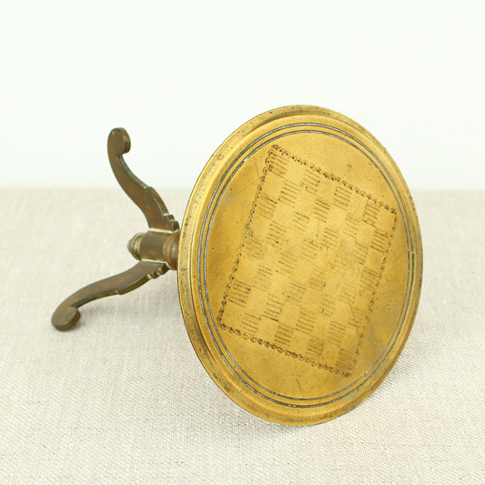 A 19th century Victorian miniature brass tilt top tripod table candle reflector