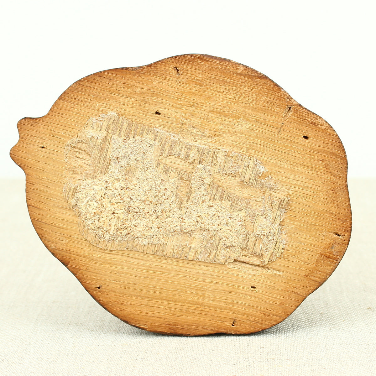 Treen - a carved oak fragment or furniture embellishment, carved as a mask with glass eyes