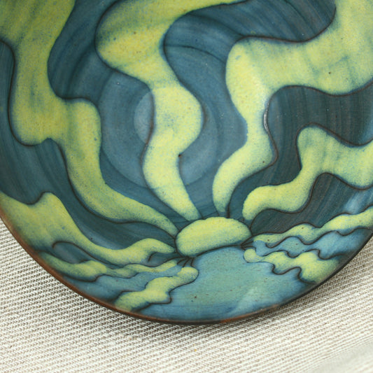 Tessa Fuch (British 1936-2012), matte glazed bowl, decorated with a sunrise design in blue and yellow tones, 16cm diameter, impressed initials to base