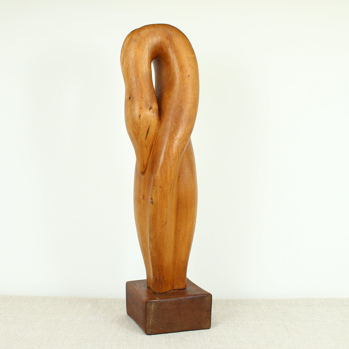 Jean W Cubrie (French)  - a wooden sculpture, Cygne Mysterieux (Mysterious Swan), inscribed to base, 42cm high overall
