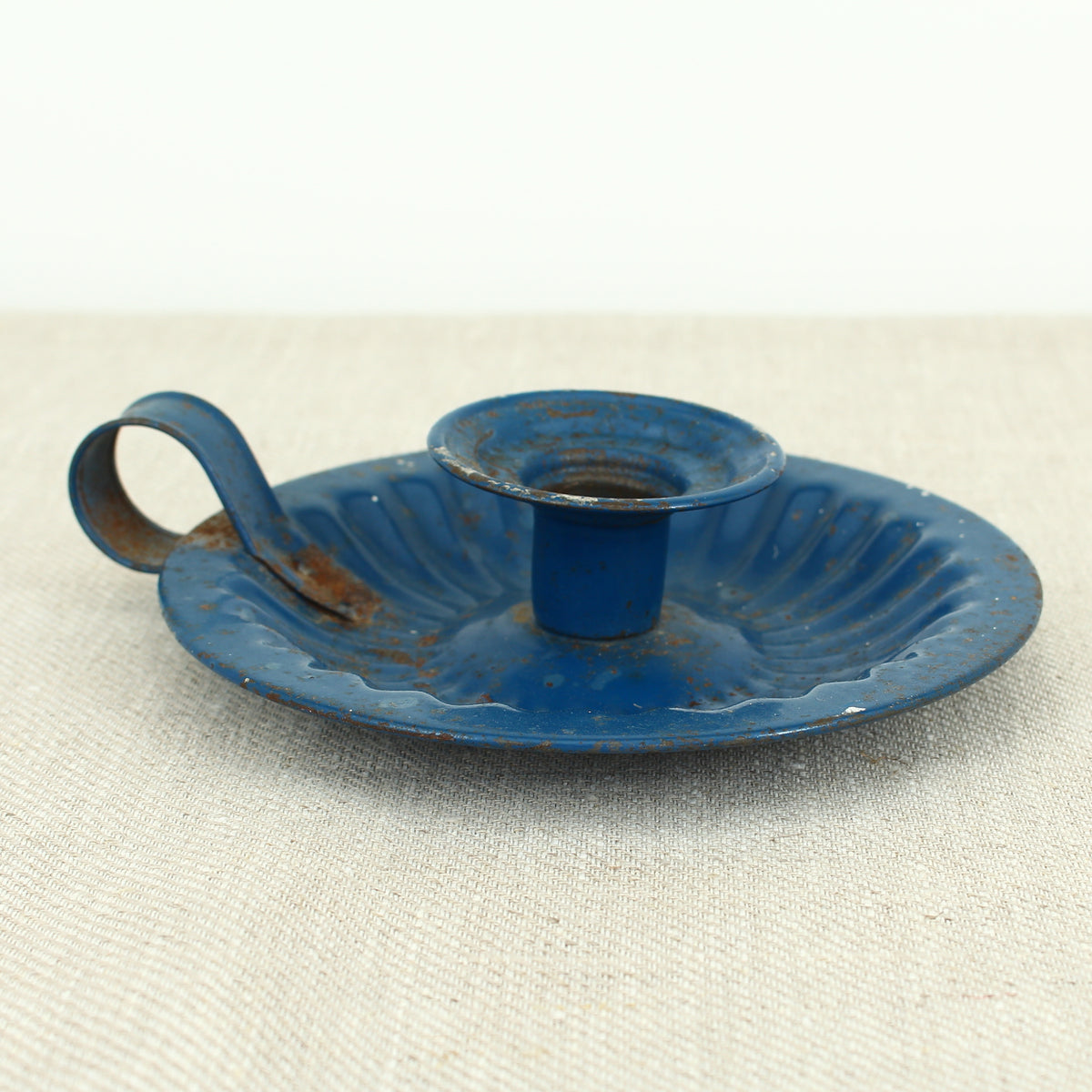 A vintage blue metal chamberstick/candle holder, simple loop handle, 16cm diameter