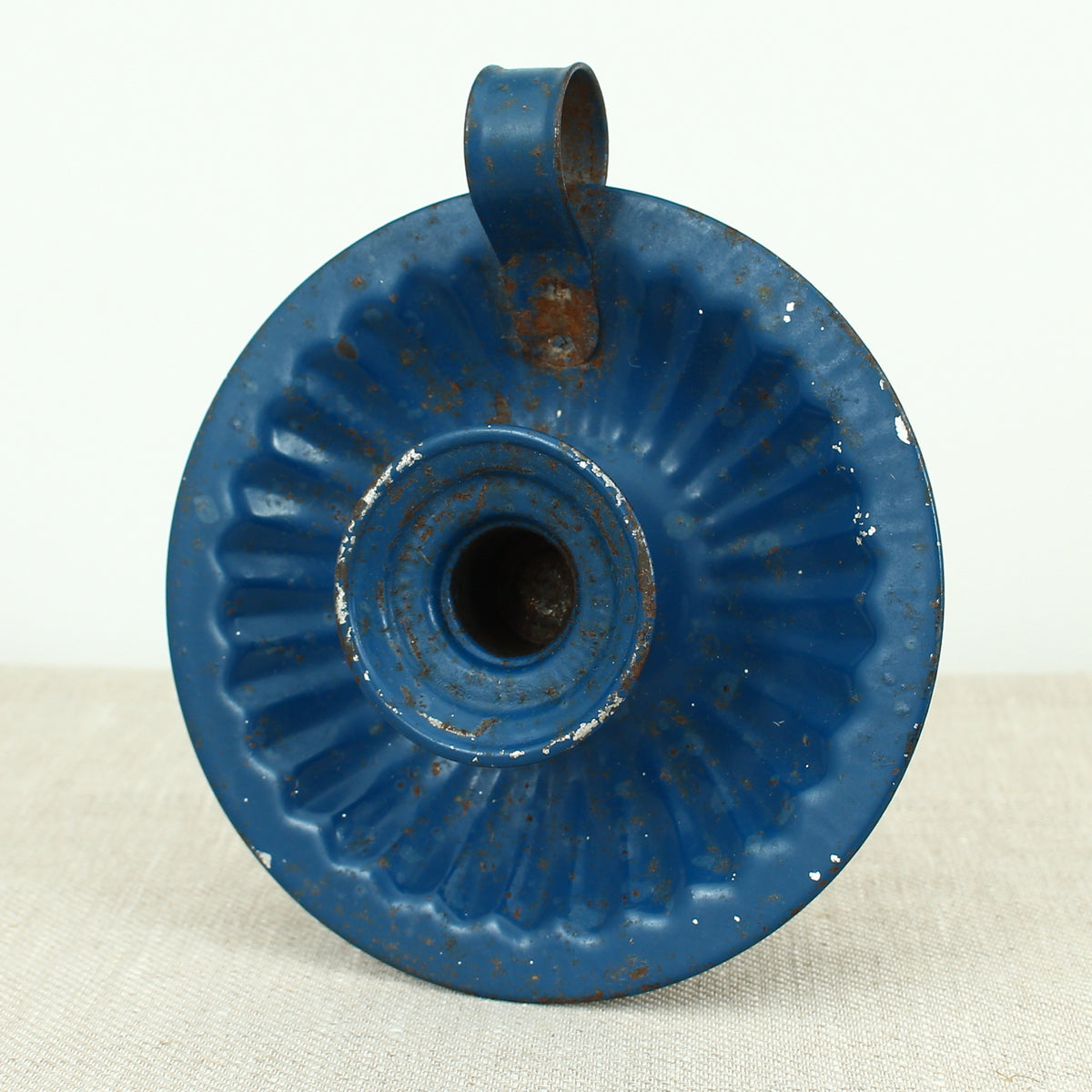 A vintage blue metal chamberstick/candle holder, simple loop handle, 16cm diameter