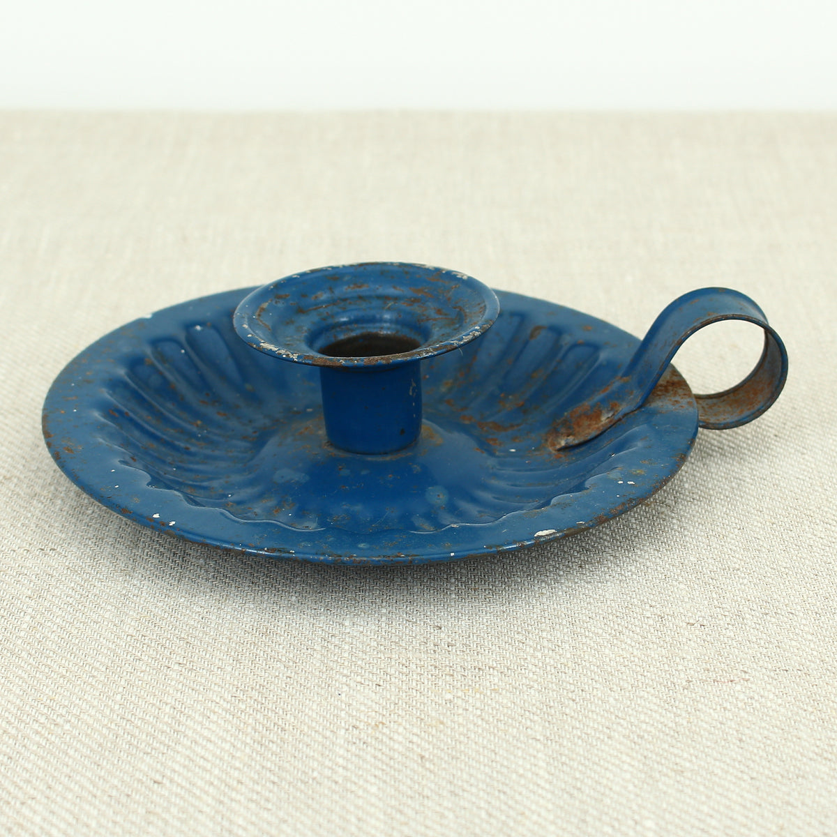 A vintage blue metal chamberstick/candle holder, simple loop handle, 16cm diameter