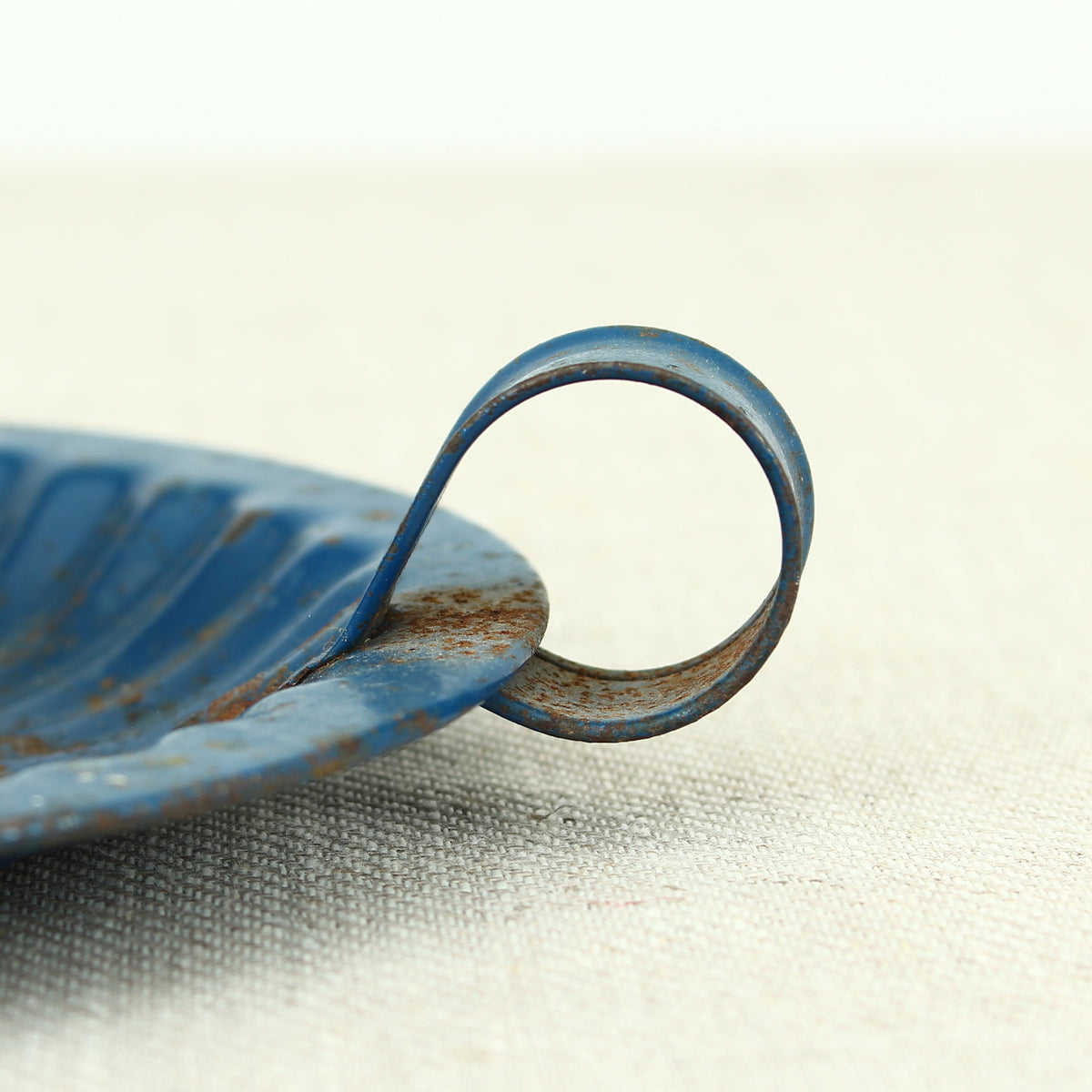 A vintage blue metal chamberstick/candle holder, simple loop handle, 16cm diameter