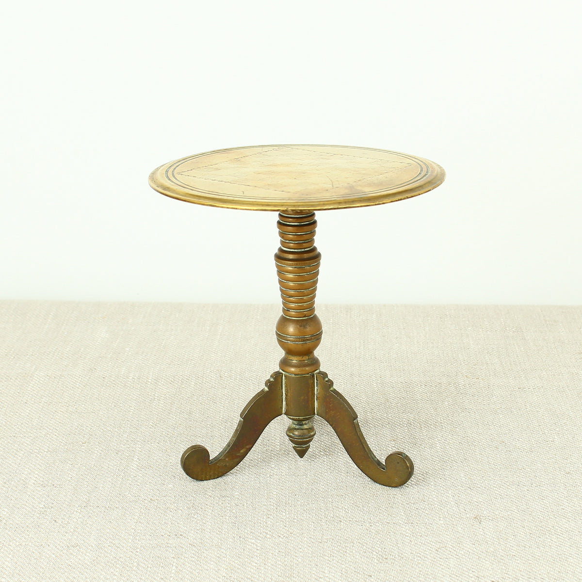 A 19th century Victorian miniature brass tilt top tripod table candle reflector