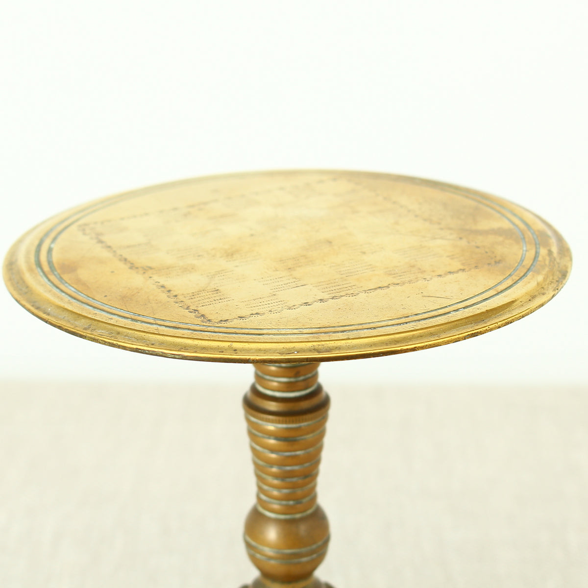 A 19th century Victorian miniature brass tilt top tripod table candle reflector