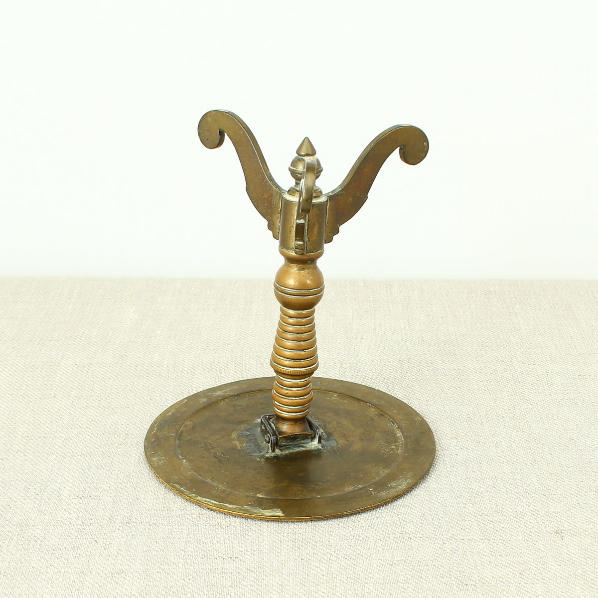 A 19th century Victorian miniature brass tilt top tripod table candle reflector