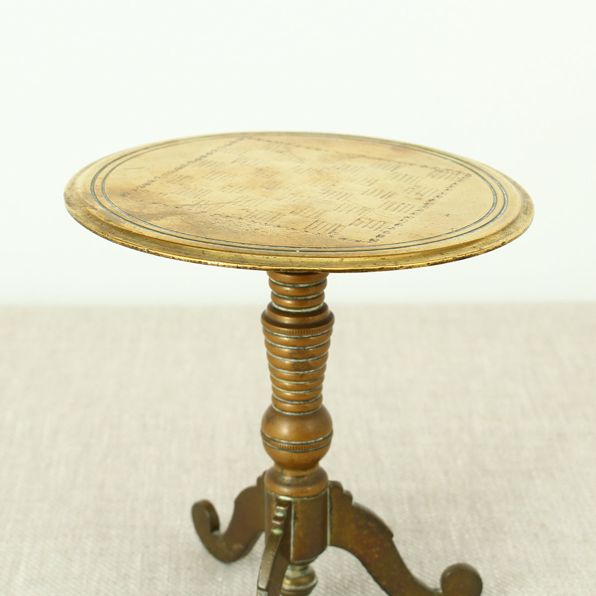 A 19th century Victorian miniature brass tilt top tripod table candle reflector