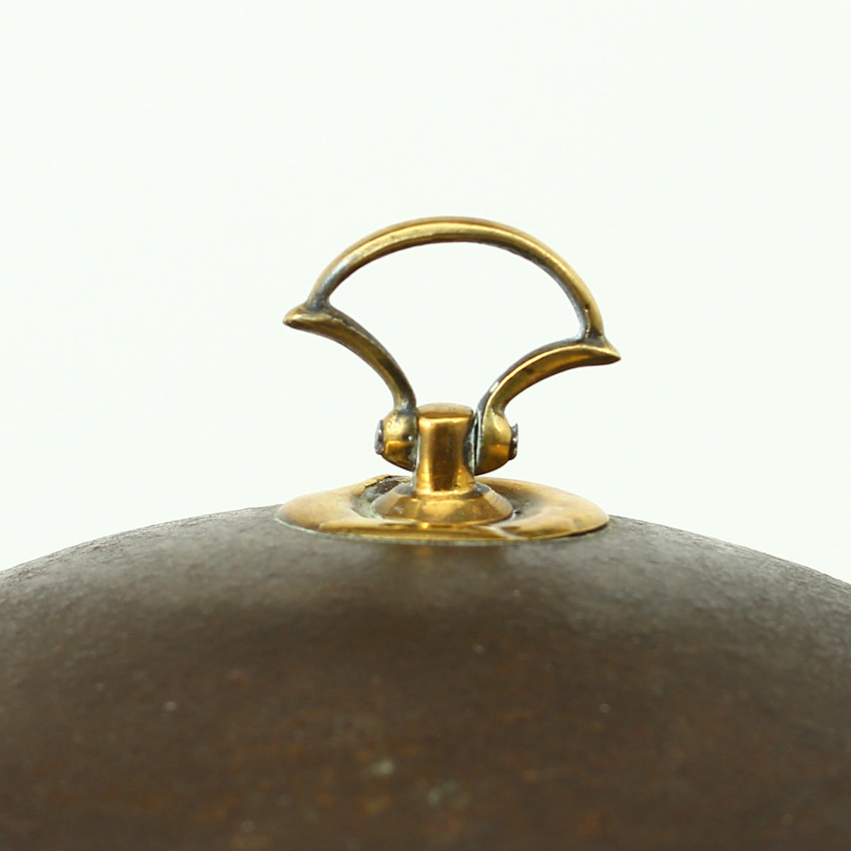 A 19th century metal circular spice tin, the fitted interior with sectional divides, domed lid with brass ring handle, metal clasp, 11cm high, 17cm diameter