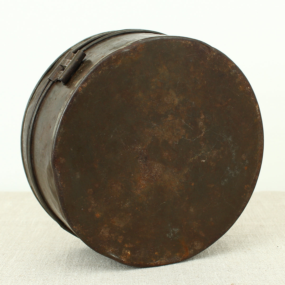 A 19th century metal circular spice tin, the fitted interior with sectional divides, domed lid with brass ring handle, metal clasp, 11cm high, 17cm diameter