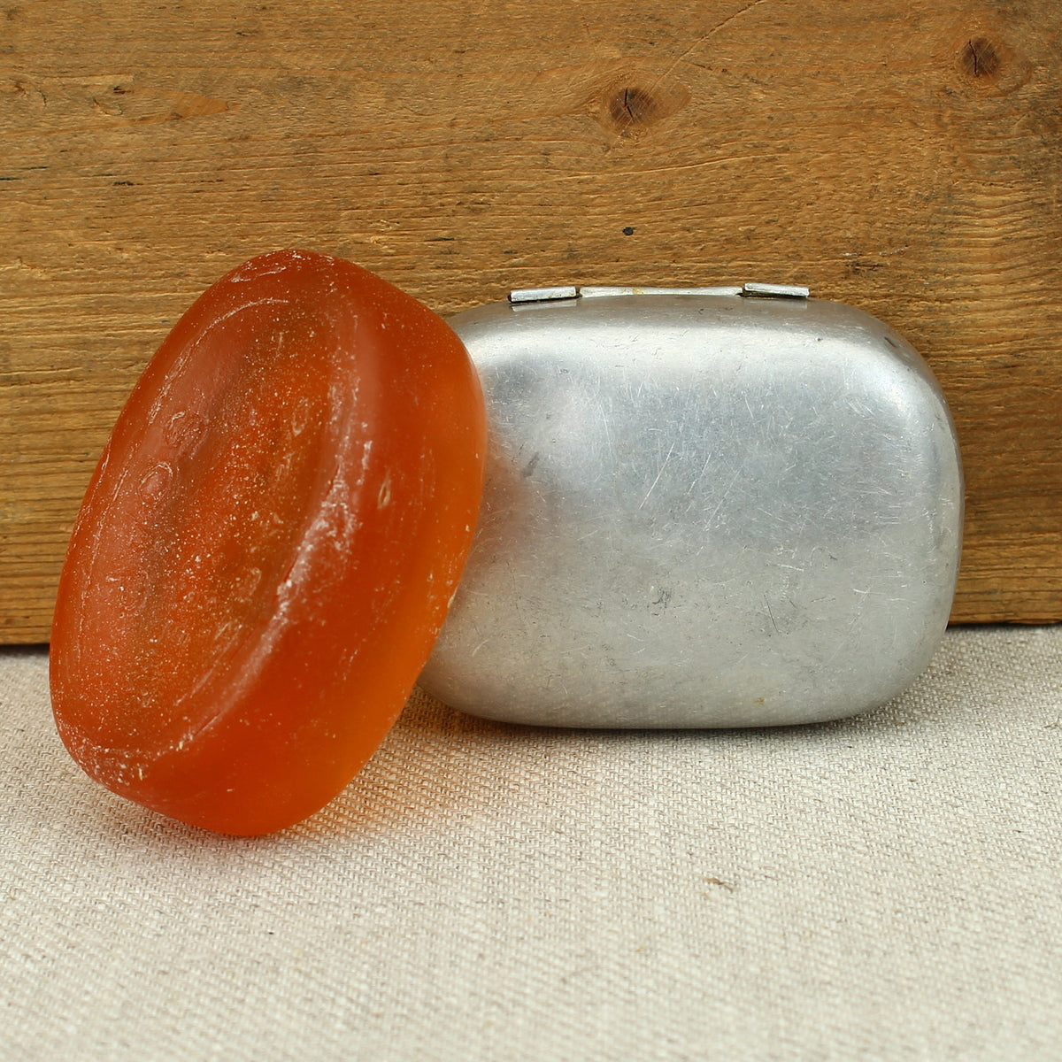 A World War II British Army aluminium soap tin, impressed marks 'W.S.L., 1945, (Broad Arrow), CC 1114'