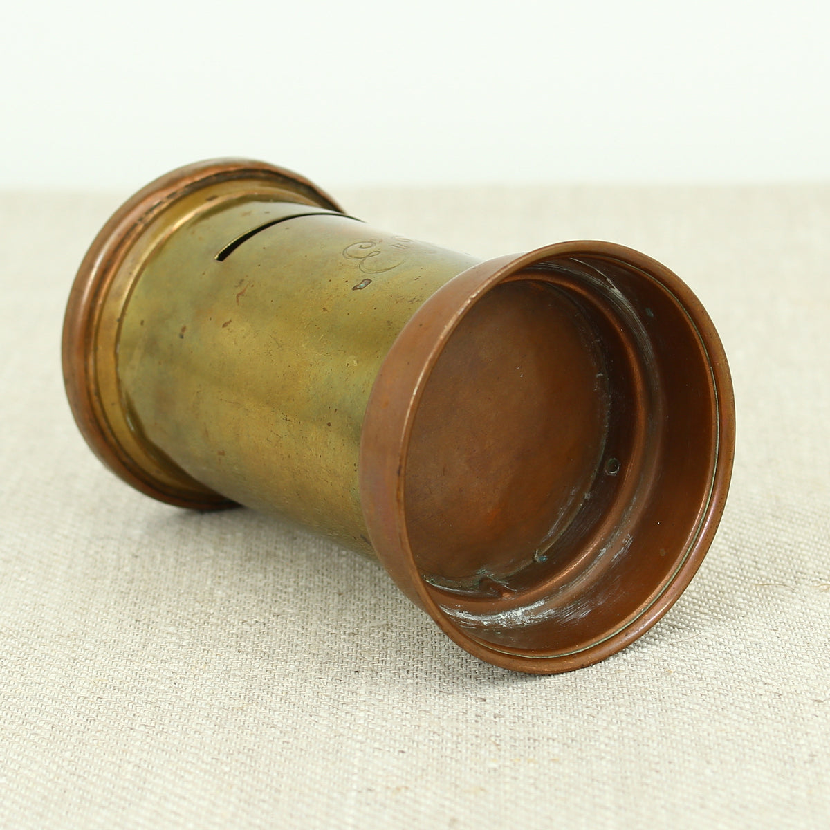 A vintage brass and copper novelty money box or money bank, in the form of a British pillar box
