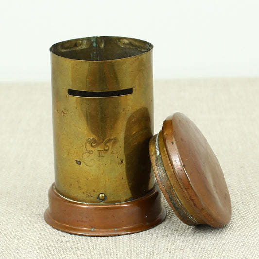 A vintage brass and copper novelty money box or money bank, in the form of a British pillar box