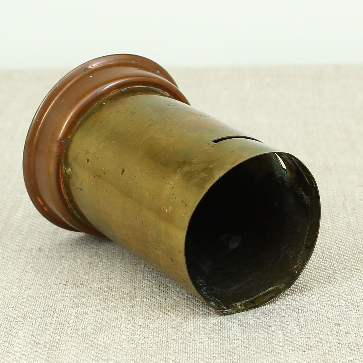 A vintage brass and copper novelty money box or money bank, in the form of a British pillar box