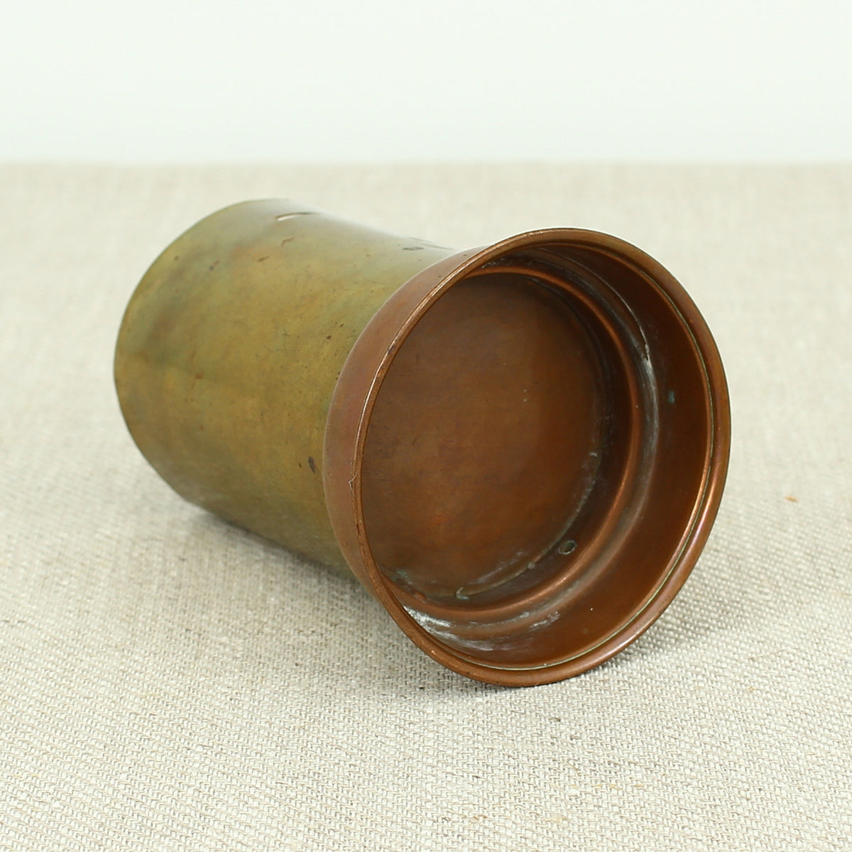 A vintage brass and copper novelty money box or money bank, in the form of a British pillar box