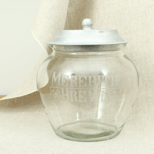 Advertising - an early 20th century glass shop counter-top biscuit jar and cover, Meredith & Drew