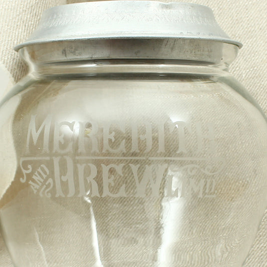 Advertising - an early 20th century glass shop counter-top biscuit jar and cover, Meredith & Drew