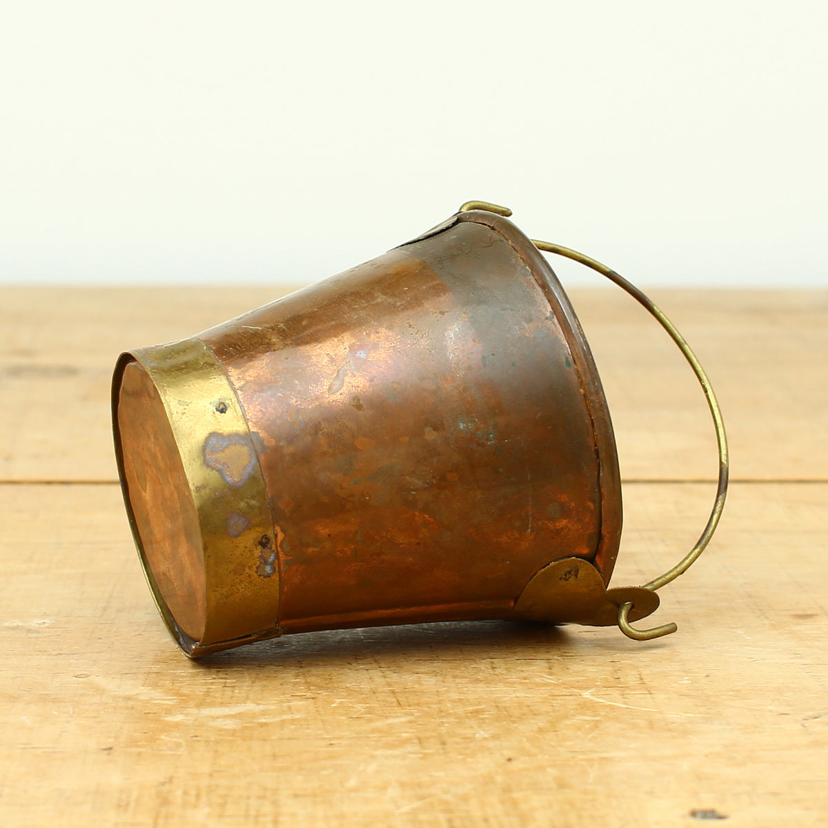 A collection of four early 20th century copper and brass miniature buckets