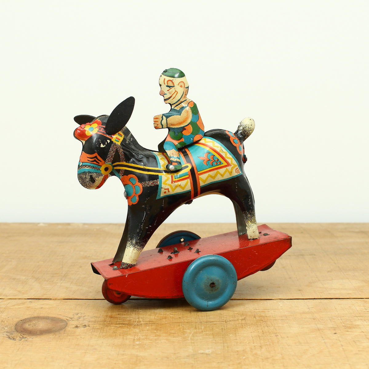 Toys & Juvenalia - a novelty tinplate and fixed clockwork mechanical toy, of a clown riding a Donkey