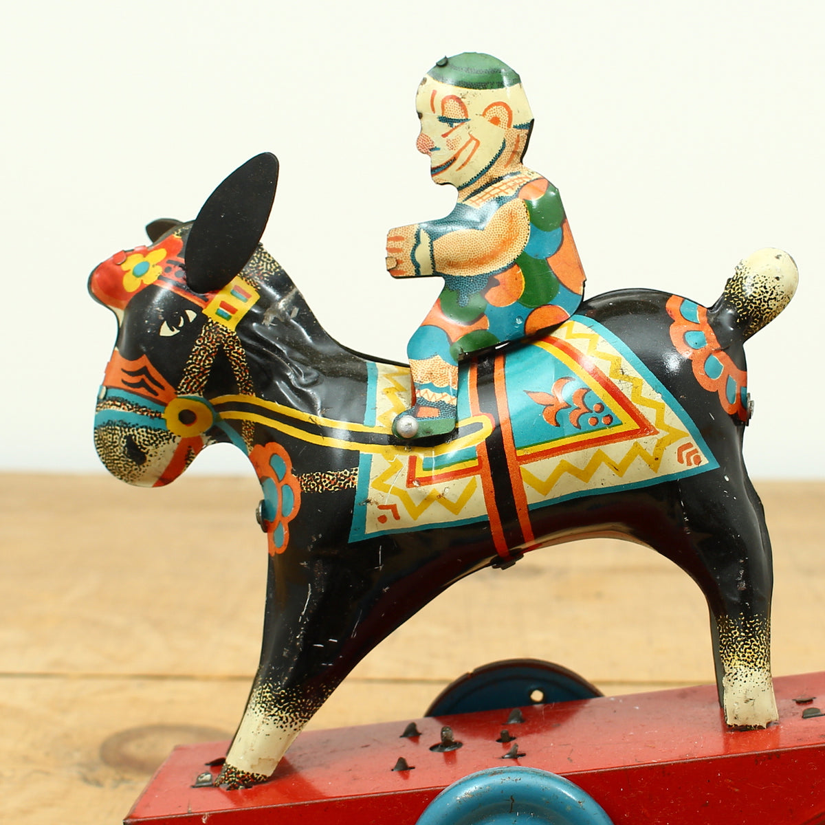 Toys & Juvenalia - a novelty tinplate and fixed clockwork mechanical toy, of a clown riding a Donkey