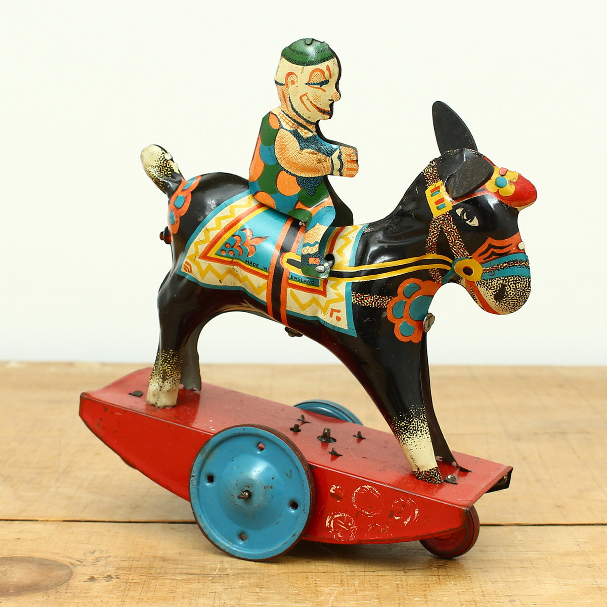 Toys & Juvenalia - a novelty tinplate and fixed clockwork mechanical toy, of a clown riding a Donkey