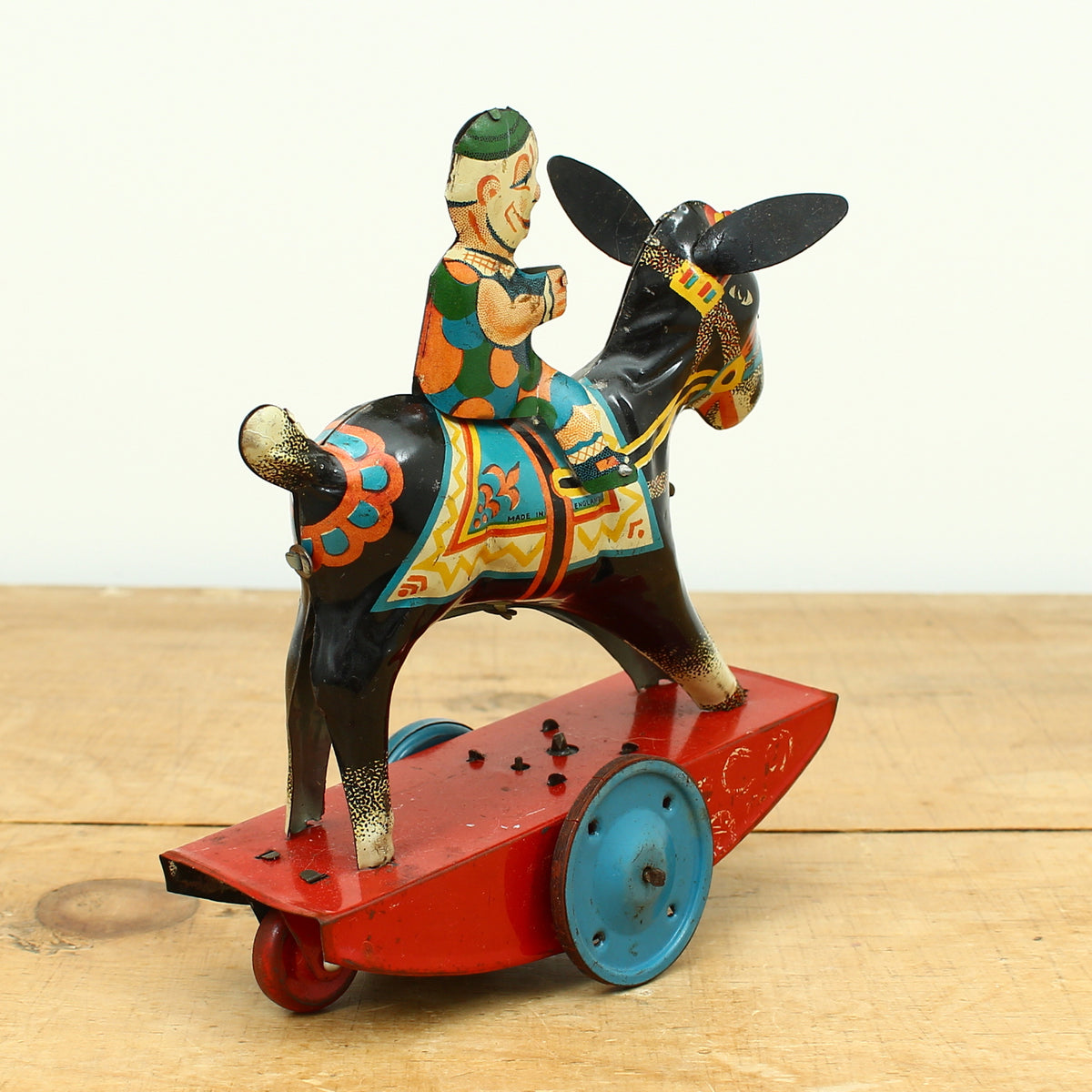 Toys & Juvenalia - a novelty tinplate and fixed clockwork mechanical toy, of a clown riding a Donkey