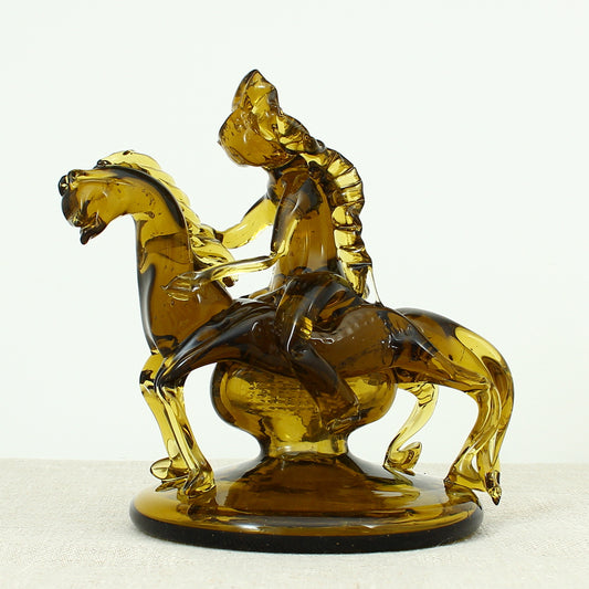 Art Glass & Mid 20th Century Design - an amber glass novelty sculpture, in the form of a Native American Indian riding a Horse with headdress, 20cm high, circular base with pontil marks to underside of base