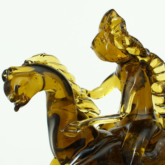 Art Glass & Mid 20th Century Design - an amber glass novelty sculpture, in the form of a Native American Indian riding a Horse with headdress, 20cm high, circular base with pontil marks to underside of base