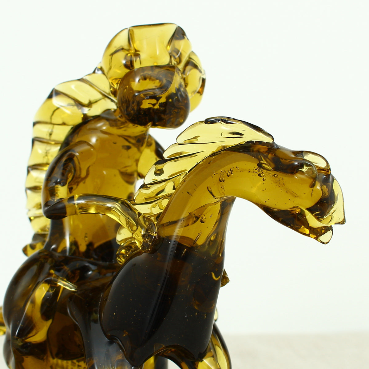 Art Glass & Mid 20th Century Design - an amber glass novelty sculpture, in the form of a Native American Indian riding a Horse with headdress, 20cm high, circular base with pontil marks to underside of base