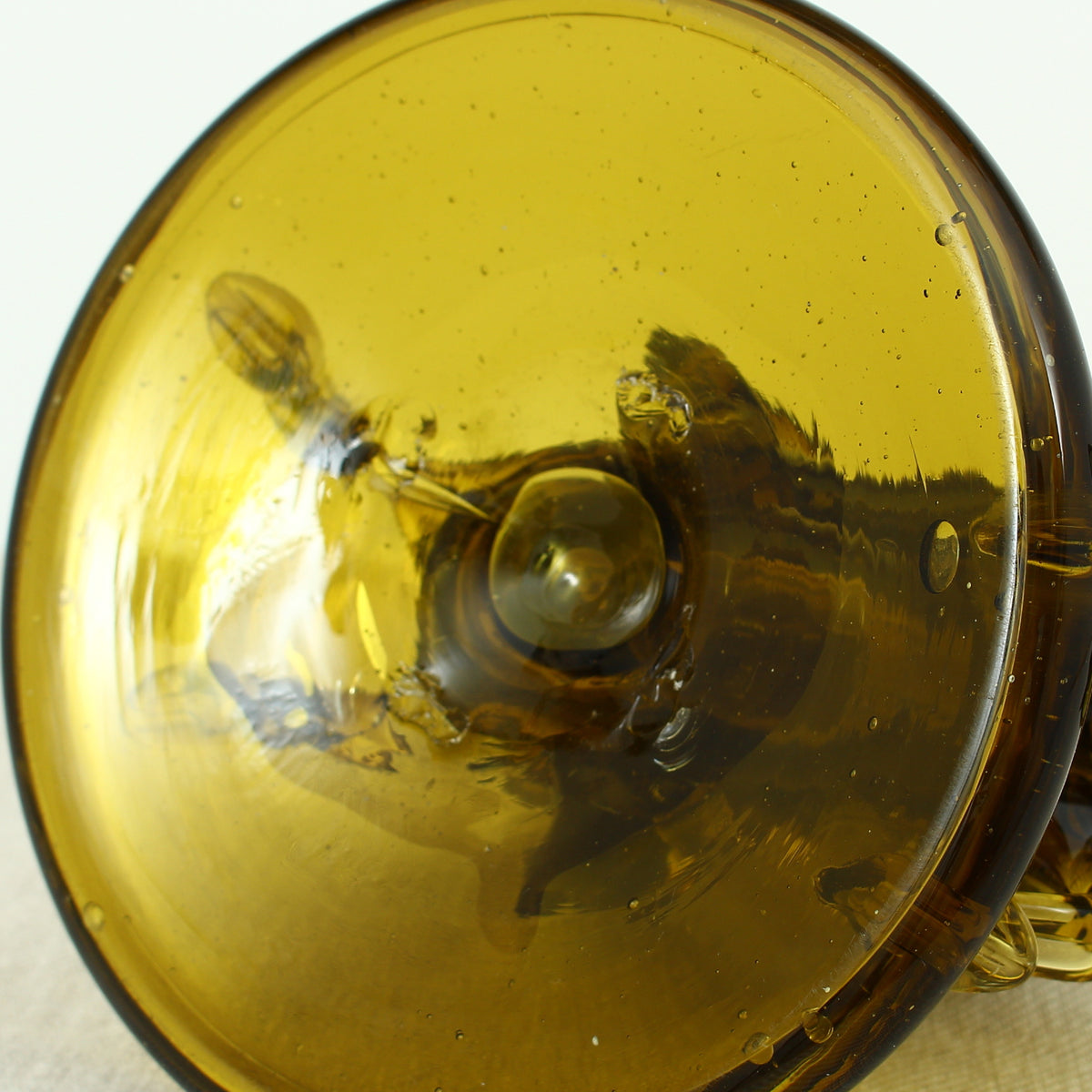 Art Glass & Mid 20th Century Design - an amber glass novelty sculpture, in the form of a Native American Indian riding a Horse with headdress, 20cm high, circular base with pontil marks to underside of base
