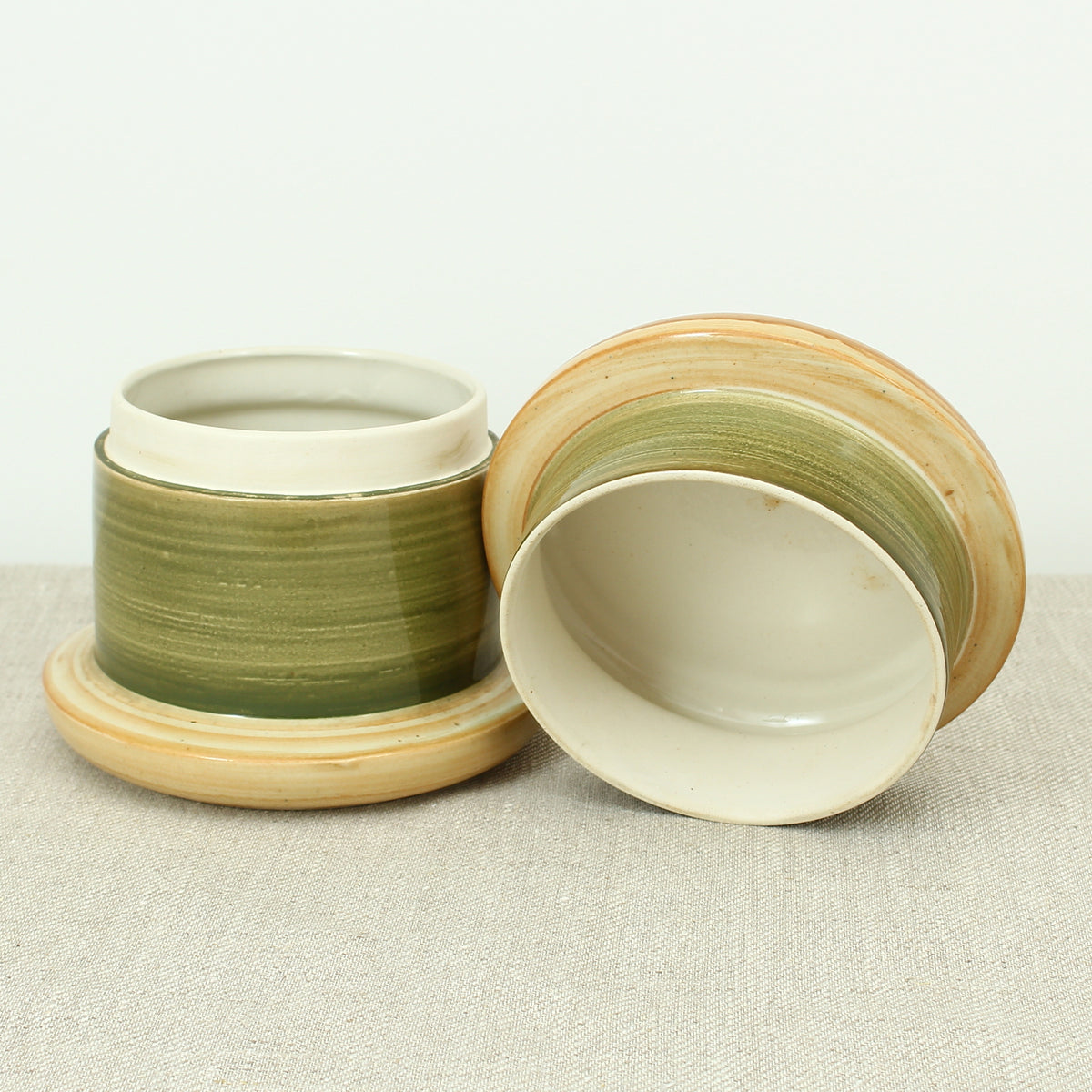 Advertising & Haberdashery Interest - a novelty ceramic jar, in the form of a faux oversized cotton reel, press close cover with printed design, 'DEWHURST'S SYLKO THREE SHELLS, MACHINE TWIST 40', finished in green, 15.5cm high