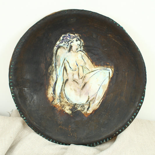 Jacqueline de la Fuente (Sculptural paper clay artist), charger with a study of a nude, serrated edge, signed and dated 2009 to the lower left edge, 34cm diameter