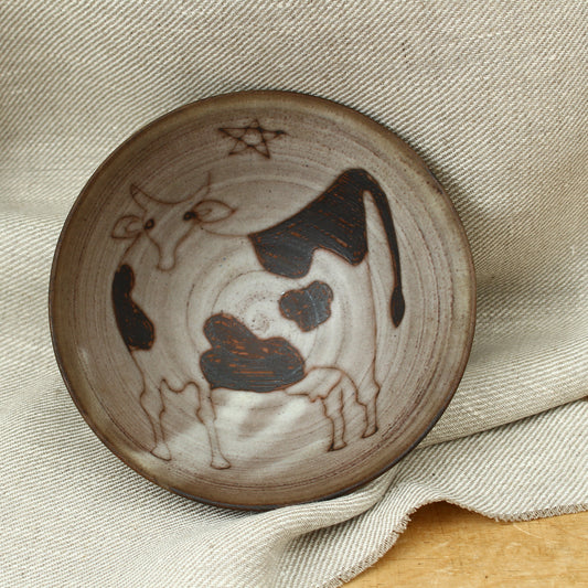 Tessa Fuch (British 1936-2012), matte glazed bowl, decorated with a stylized Cow and star, 16cm diameter, impressed initials to base