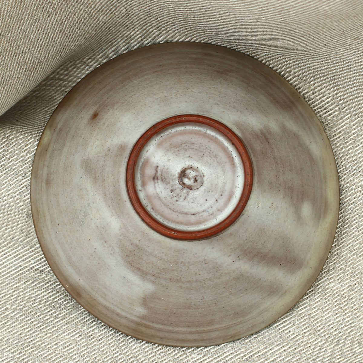 Tessa Fuch (British 1936-2012), matte glazed bowl, decorated with a stylized Cow and star, 16cm diameter, impressed initials to base