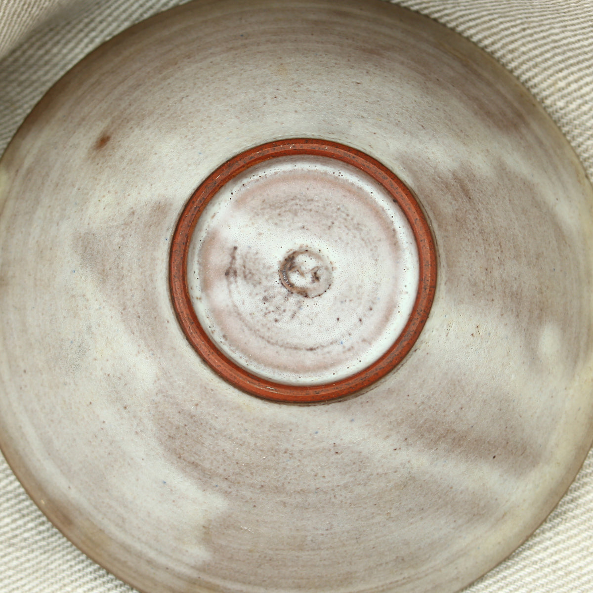Tessa Fuch (British 1936-2012), matte glazed bowl, decorated with a stylized Cow and star, 16cm diameter, impressed initials to base