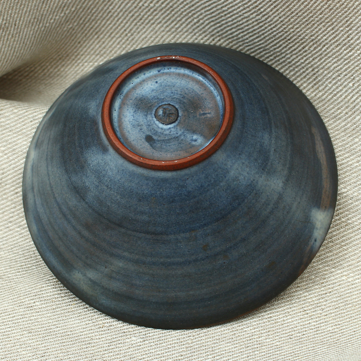 Tessa Fuch (British 1936-2012), matte glazed bowl, decorated with a stylized Bird and star, 16cm diameter, impressed initials to base