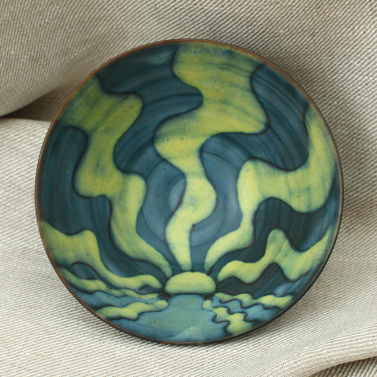 Tessa Fuch (British 1936-2012), matte glazed bowl, decorated with a sunrise design in blue and yellow tones, 16cm diameter, impressed initials to base