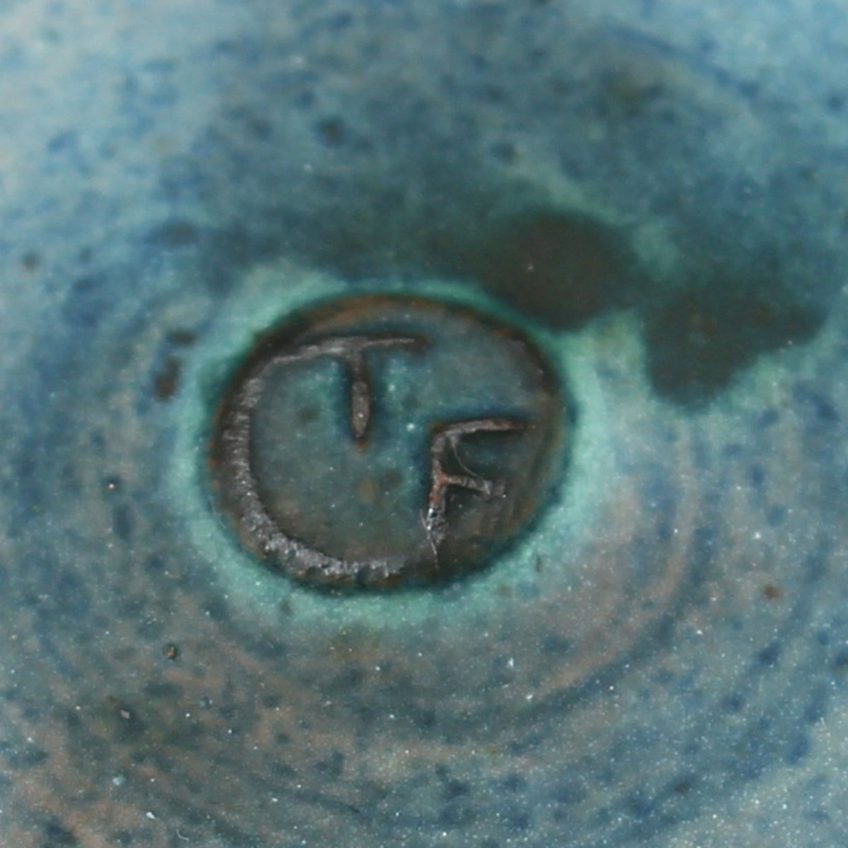 Tessa Fuch (British 1936-2012), matte glazed bowl, decorated with a sunrise design in blue and yellow tones, 16cm diameter, impressed initials to base
