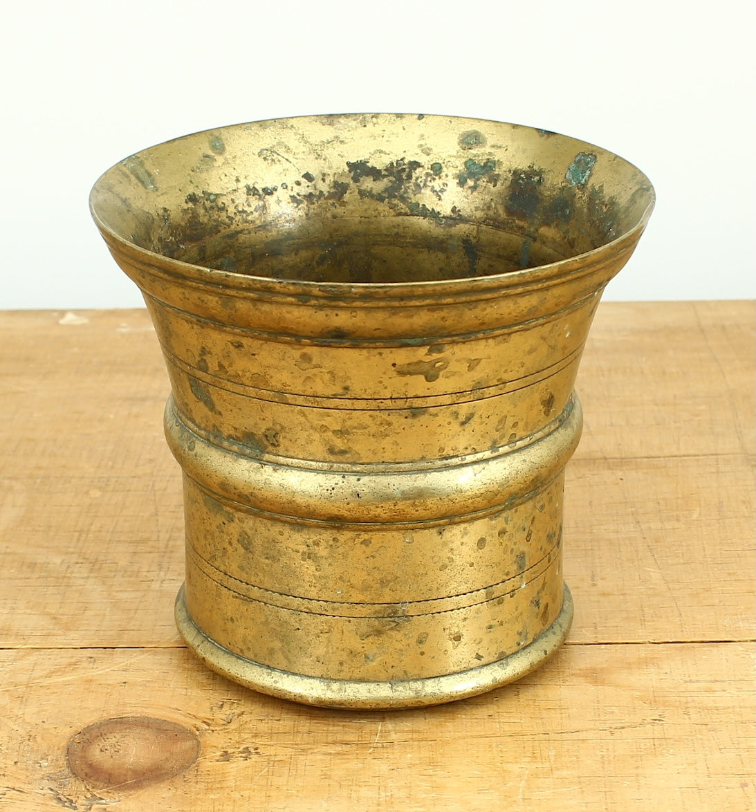 A 19th century bronze mortar and pestle, cylindrical form with girdle and everted rim