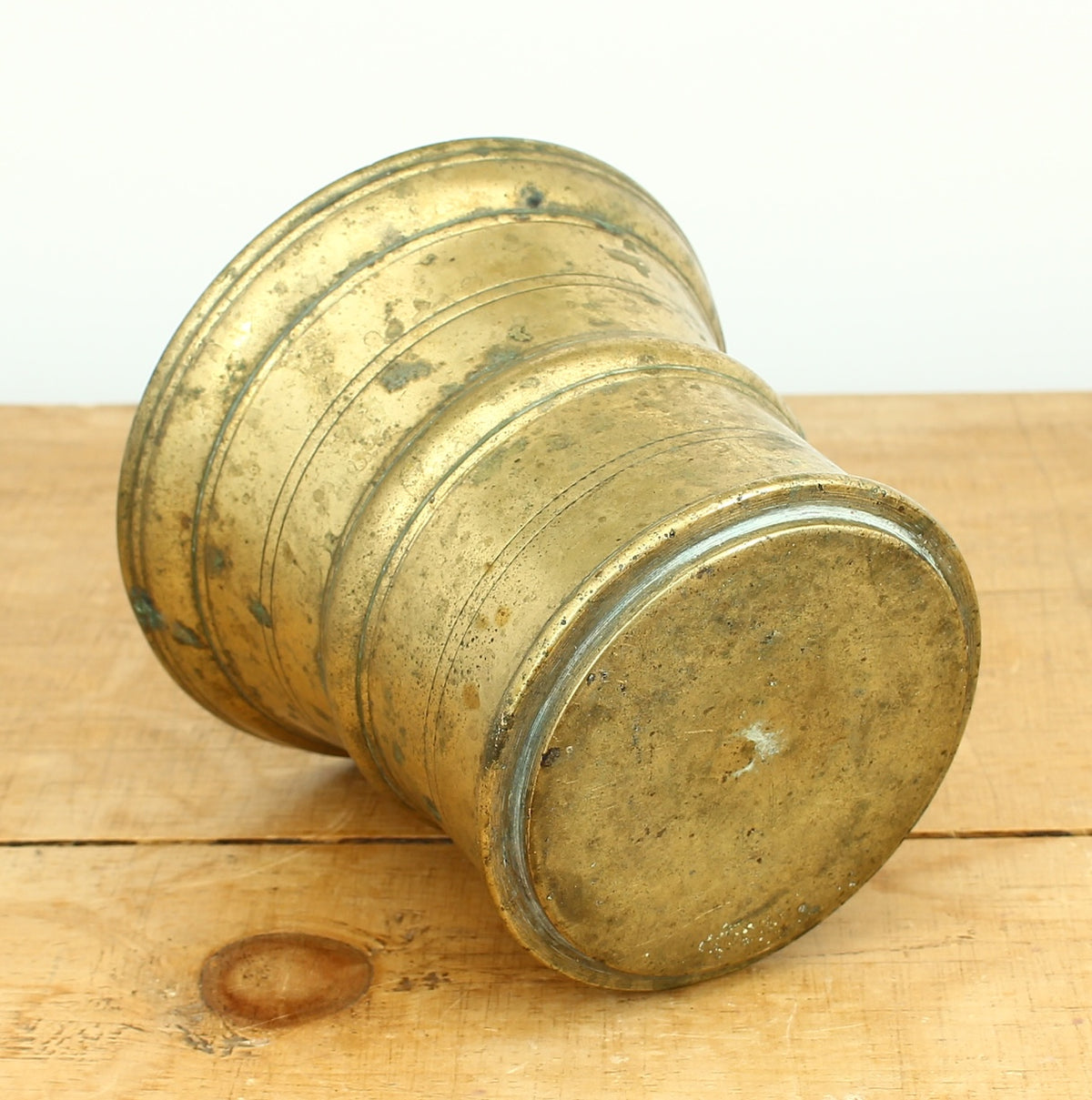 A 19th century bronze mortar and pestle, cylindrical form with girdle and everted rim