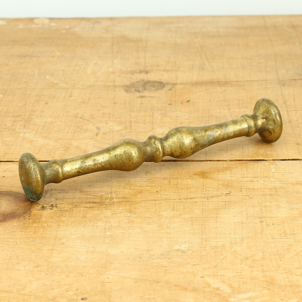 A 19th century bronze mortar and pestle, cylindrical form with girdle and everted rim