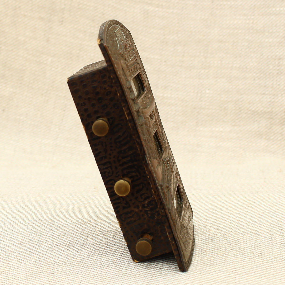 An early 20th century Japanese perpetual desk calendar, the cast metal face plate probably manufactured from antimony or a similar alloy
